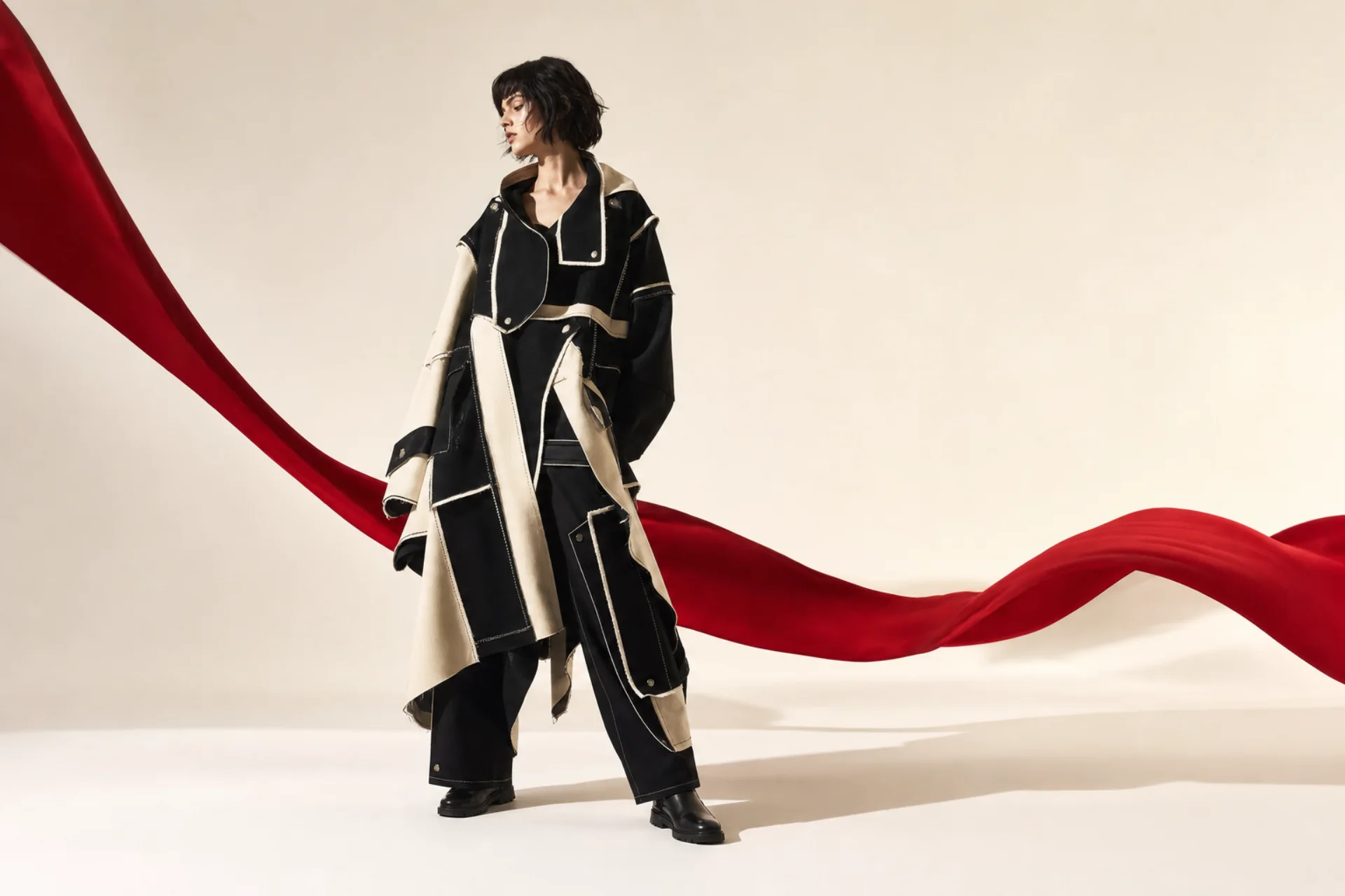 Model in a sculptural black and ivory modular coat